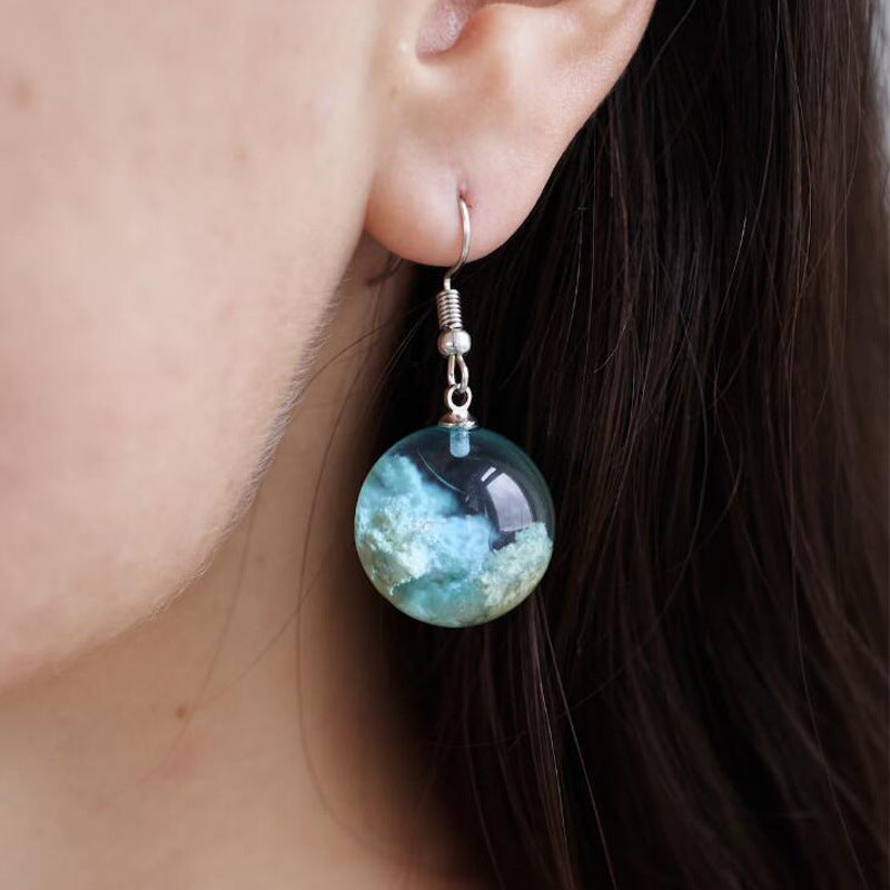Add a touch of blue sky and white clouds to your look with these exquisite glass ball earrings