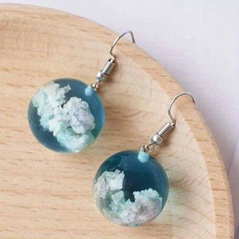 Add a touch of blue sky and white clouds to your look with these exquisite glass ball earrings