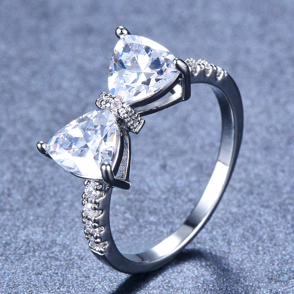 Sparkle on Your Special Day with Our White Crystal Marriage Ring - Ladies Silver Four Claw Bow Ring with Geometric Zircon Design - Perfect Birthday, Engagement or Wedding Gift for Women - Elegant Rhinestone Jewelry Accessory